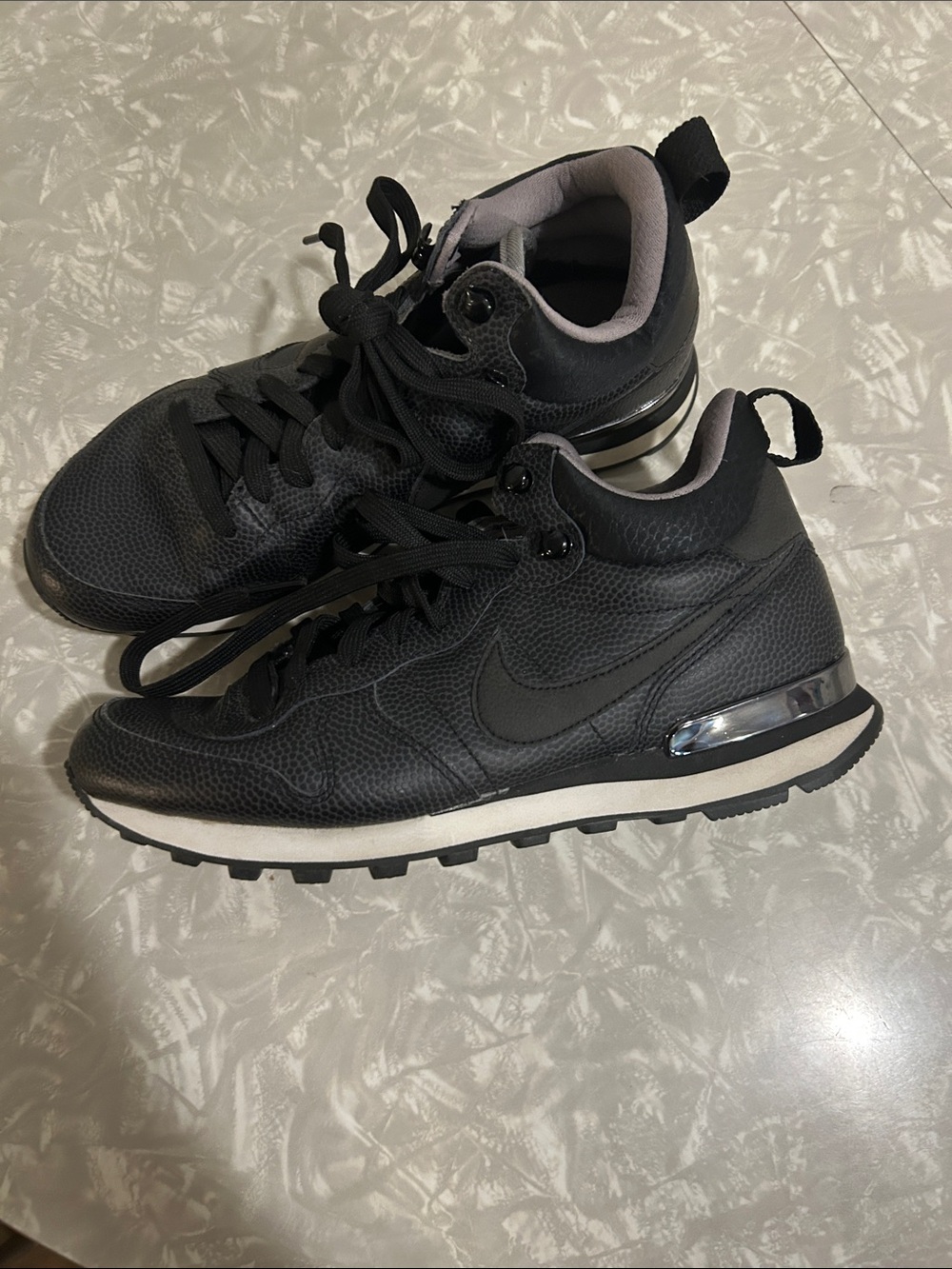 Nike Black Low-Top Leather Sneakers with Silver Heel Accent